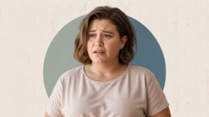 A woman with short brown hair wearing a light pink shirt looks concerned about hunger or weight loss, standing in front of a background with a large blue circle.