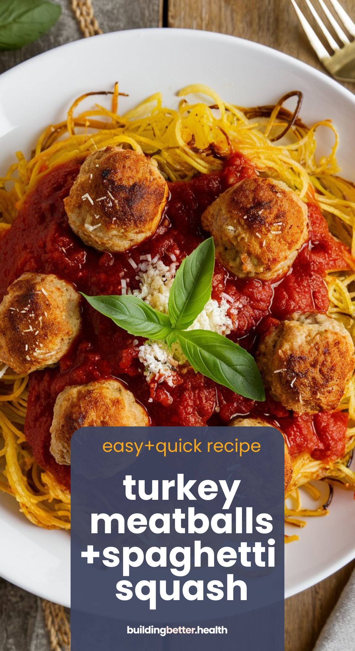 A white plate brimming with turkey meatballs with spaghetti squash, topped with red sauce. Grated cheese and basil leaves add a final touch. A text overlay reads, easy + quick recipe, turkey meatballs + spaghetti squash, at buildingbetter.health.
