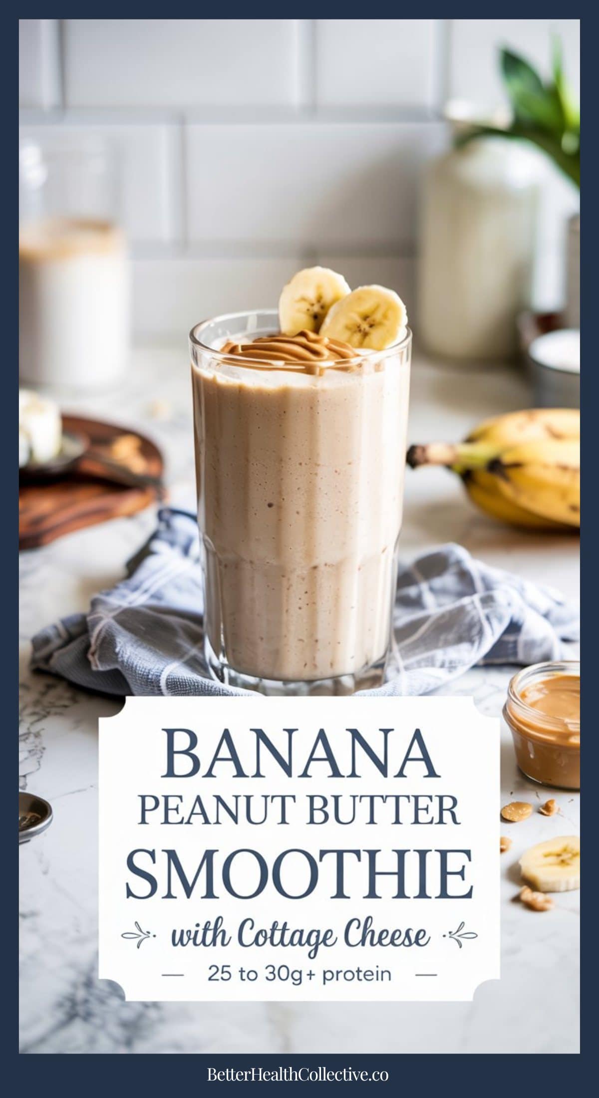 A glass of high protein banana peanut butter smoothie with cottage cheese, topped with banana slices and peanut butter, sits on a cloth. Peanut butter, bananas, and kitchen items are in the background. Text reads “Banana Peanut Butter Smoothie with Cottage Cheese.”.