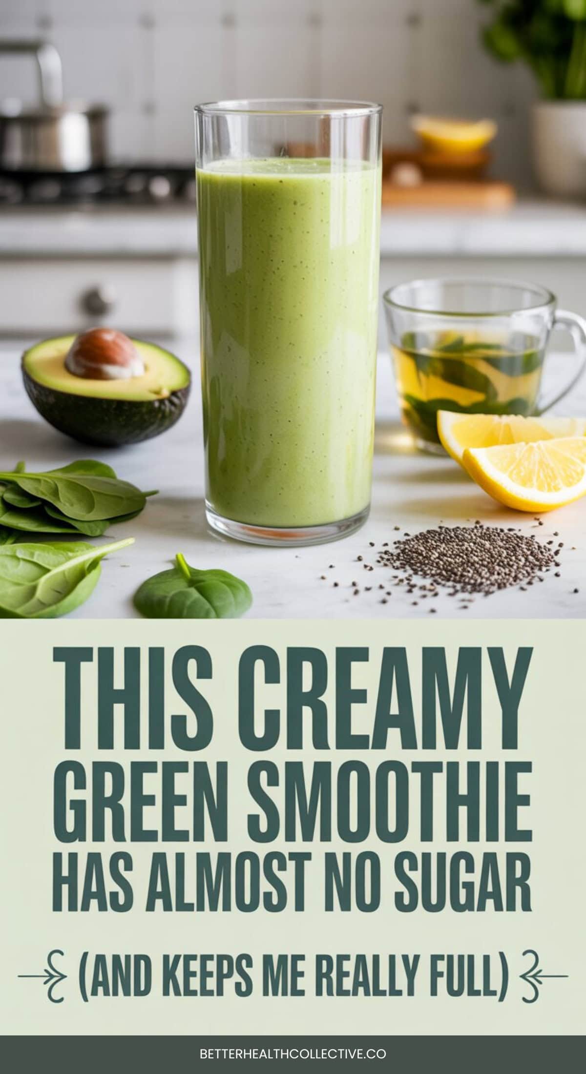 A tall glass of creamy green smoothie sits on a kitchen counter near half an avocado, lemon slices, chia seeds, and a cup of herbal tea. Text below reads, “This low sugar smoothie keeps me really full—and it’s so creamy!”.