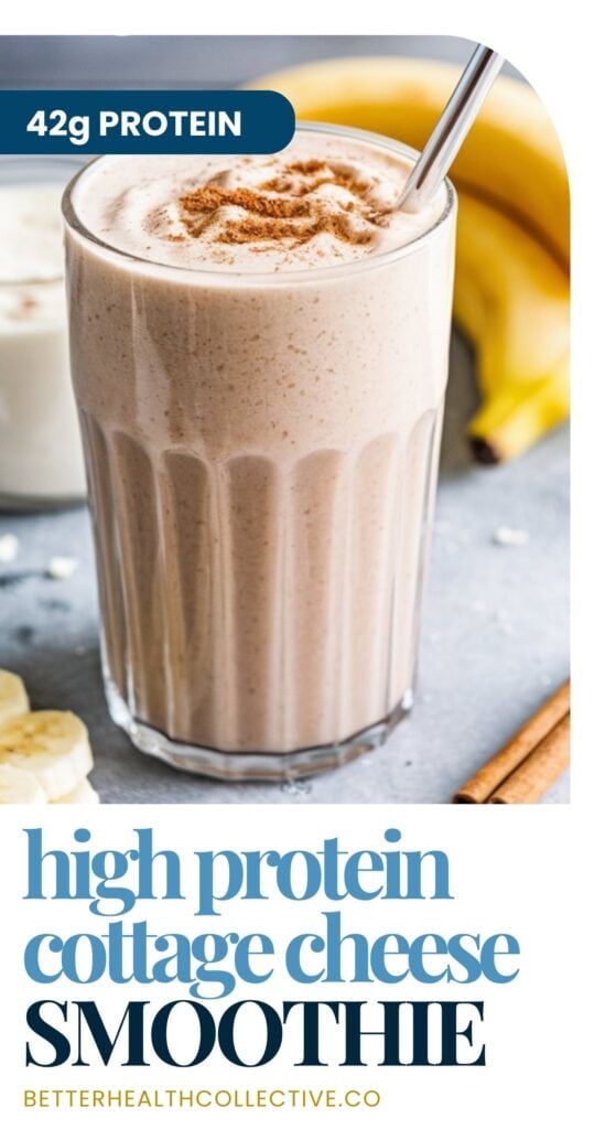 A glass of creamy cottage cheese smoothie topped with cinnamon sits on a grey surface next to sliced bananas, a whole banana, and a cinnamon stick. A metal straw is in the glass. Text reads 42g protein and high-protein smoothies.