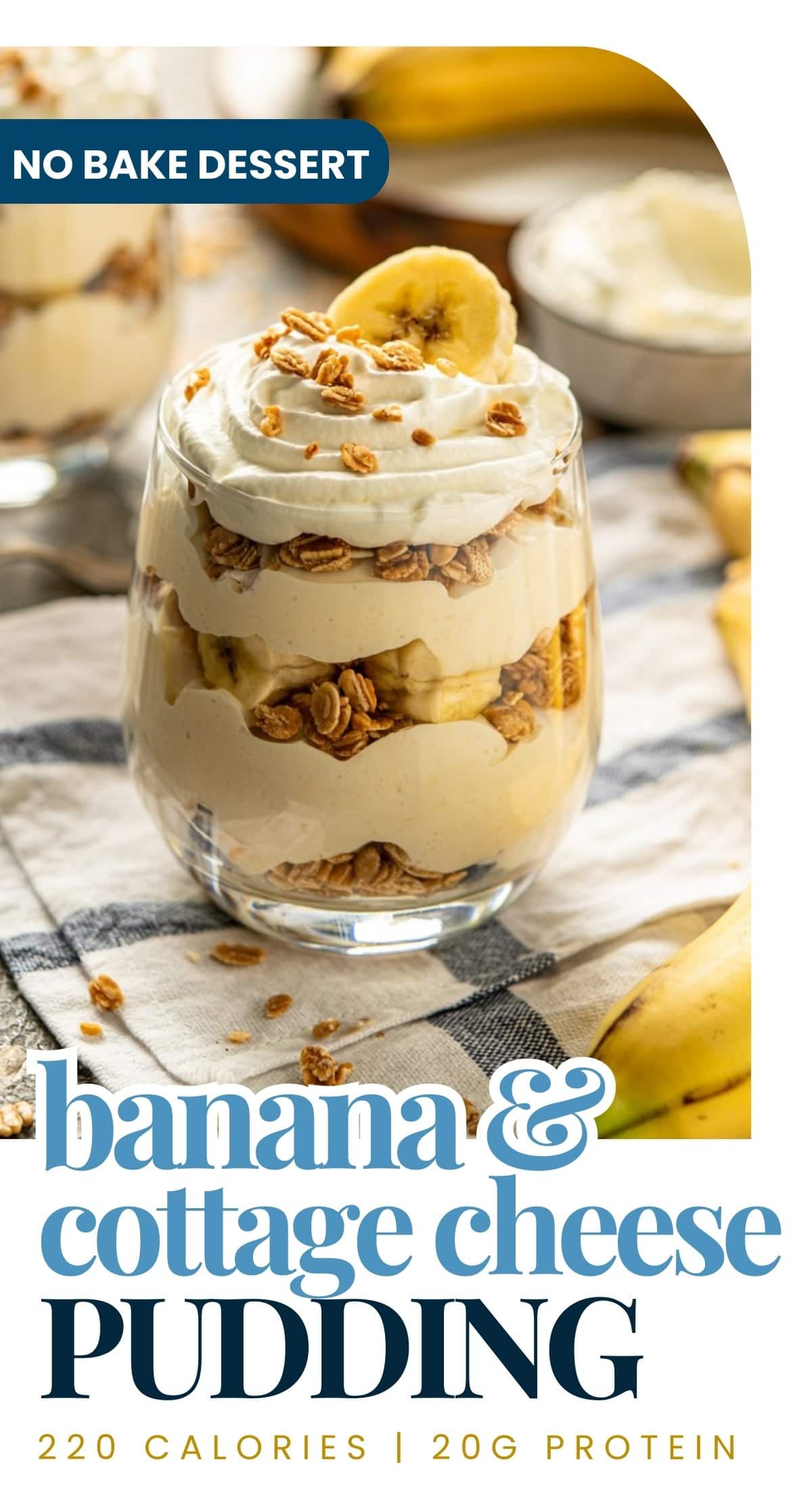 A glass filled with layered cottage cheese banana pudding, topped with whipped cream, granola, and a banana slice. This high-protein dessert is no-bake with just 220 calories and 20g of protein per serving.