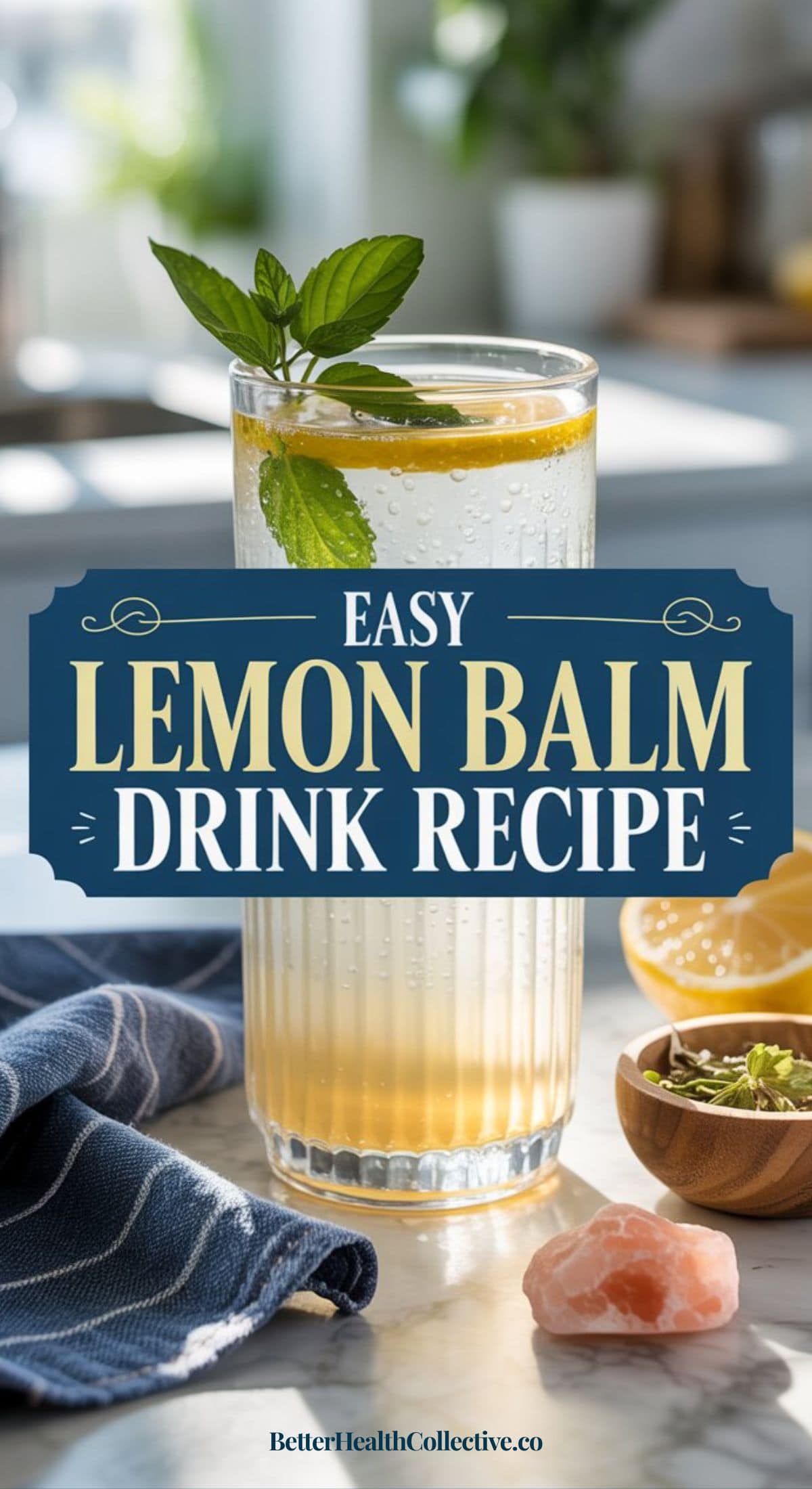 A tall glass of a refreshing Lemon Balm drink garnished with fresh mint sits on a kitchen counter by a blue towel, with ingredients and a Himalayan salt crystal nearby. Text reads: Easy Lemon Balm Drink Recipe.