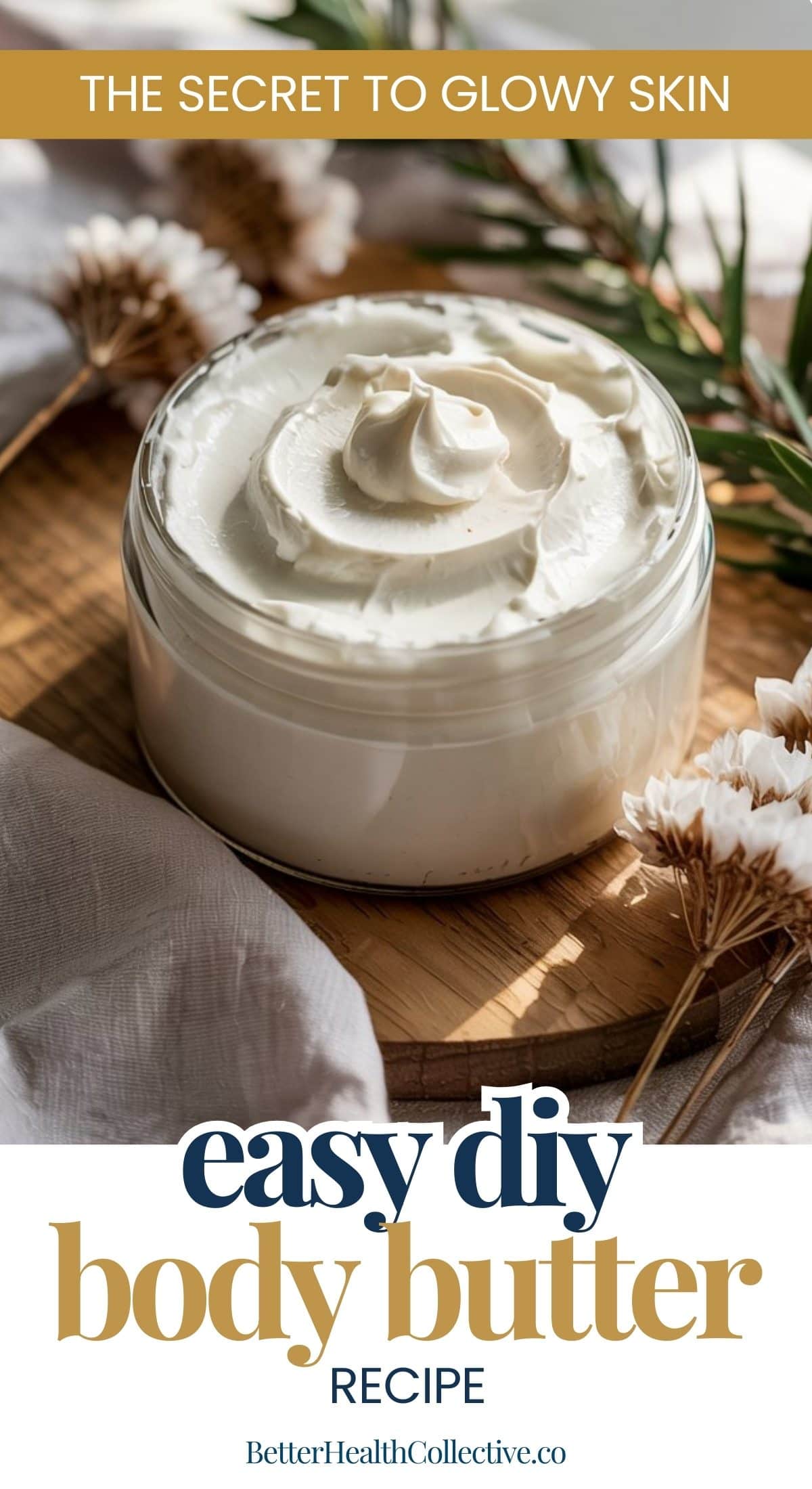 A glass jar filled with DIY body butter sits on a wooden tray, surrounded by dried flowers and a beige cloth. Text reads: The Secret to Glowing Skin. Easy DIY Body Butter Recipe. BetterHealthCollective.co.