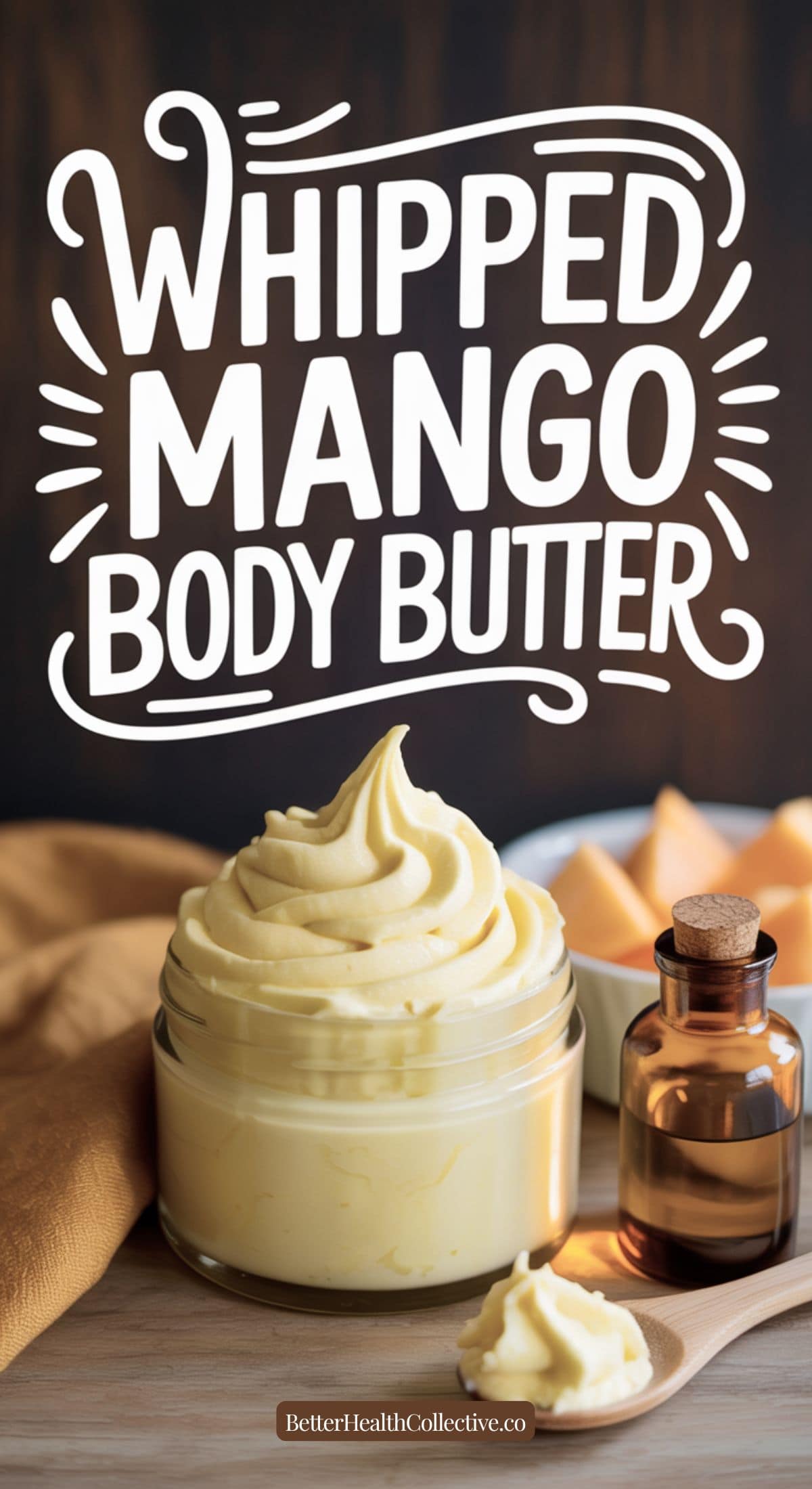 A jar of lightweight, whipped mango body butter sits on a table with a small bottle of oil, a wooden spoon, and fresh mango pieces. The text reads Whipped Mango Body Butter in bold white letters—non-greasy and nourishing.