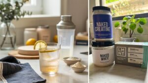A glass of lemon water, the perfect Morning Primer Drink for an energy boost, sits beside a shaker, powder, and supplement containers labeled Naked Creatine, Naked Whey, and LMNT electrolyte drink mix on a sunlit kitchen counter.